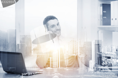 Image of businessman with laptop and smartphone at office