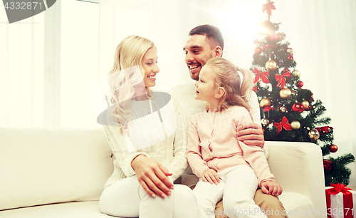 Image of happy family at home with christmas tree