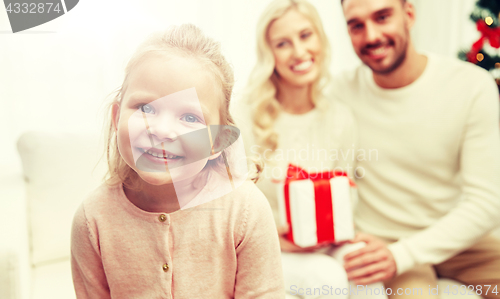 Image of happy family at home with christmas gift box