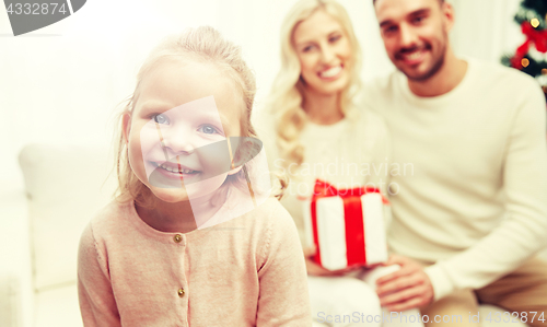 Image of happy family at home with christmas gift box