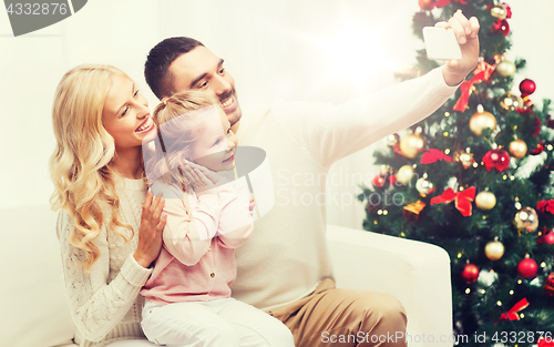 Image of family taking selfie with smartphone at christmas