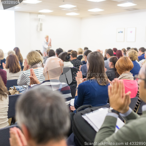 Image of Woman giving interactive motivational speech at entrepreneurship workshop.