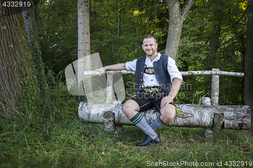 Image of bavarian tradition man in the grass