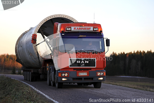 Image of MAN Truck Hauls Oversize Load on Rural Road