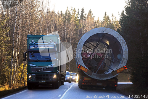 Image of Oversize Transport and Cargo Truck Pass on Narrow Road