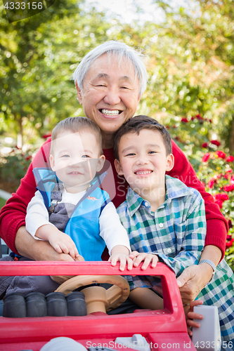 Image of Happy Senior Adult Chinese Man Playing with His Mixed Race Grand