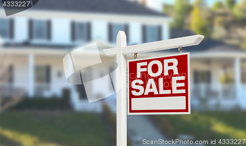 Image of Home For Sale Real Estate Sign in Front of Beautiful New House.