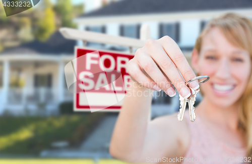 Image of Excited Woman Holding House Keys and For Sale Real Estate Sign i