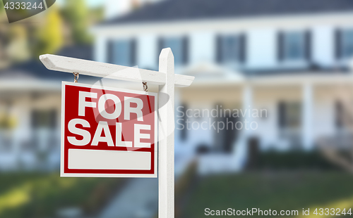 Image of Home For Sale Real Estate Sign in Front of Beautiful New House.