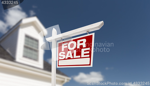 Image of Home For Sale Real Estate Sign in Front of Beautiful New House.