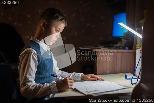 Image of pupil boy does his homework