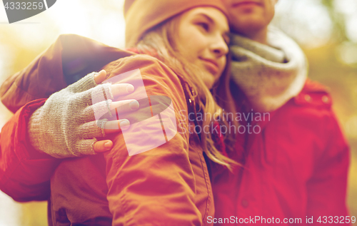 Image of close up of happy couple hugging in autumn park