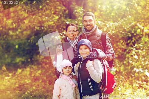Image of happy family with backpacks hiking