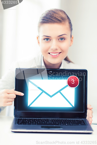 Image of businesswoman with laptop in office