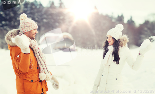 Image of happy couple playing snowballs in winter