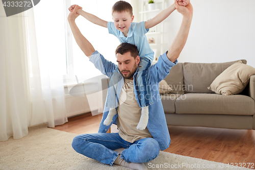 Image of father with son playing and having fun at home