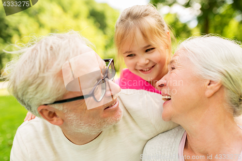 Image of senior grandparents and granddaughter at park