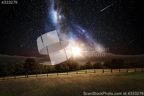 Image of landscape over space and stars in night sky