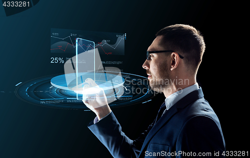 Image of businessman with tablet pc and virtual charts