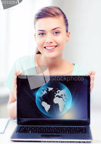 Image of woman with laptop and sphere globe