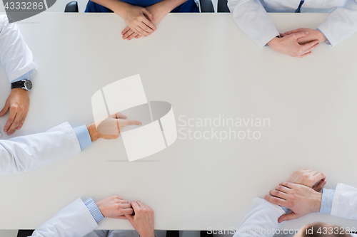Image of doctor hand showing something imaginary on table