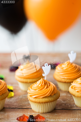 Image of cupcakes with halloween decoration on table