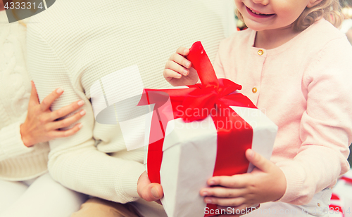 Image of close up of mother and child girl with gift box