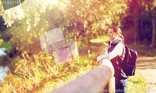 Image of happy woman with backpack outdoors