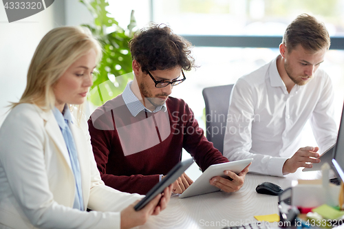 Image of business team with tablet pc at office