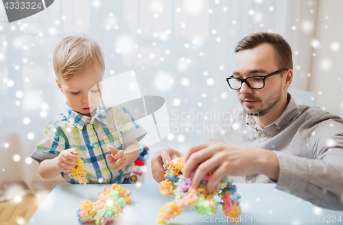 Image of father and son playing with ball clay at home