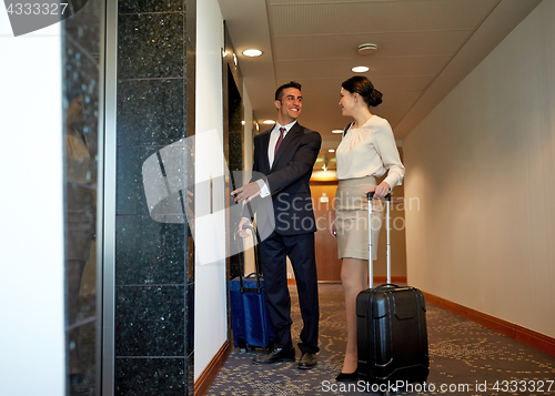 Image of business team with travel bags at hotel elevator