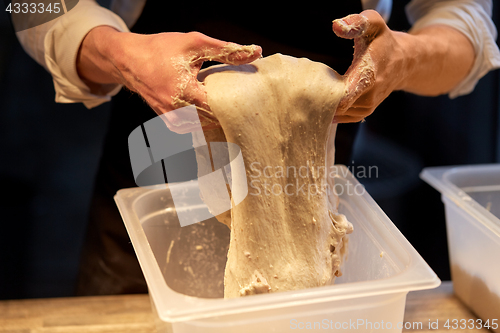 Image of close up of baker hands making bread dough