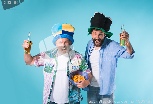 Image of The two football fans over blue