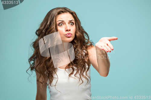 Image of Portrait of young woman with shocked facial expression