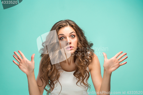 Image of Portrait of young woman with shocked facial expression