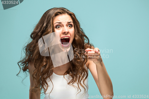 Image of Portrait of young woman with shocked facial expression