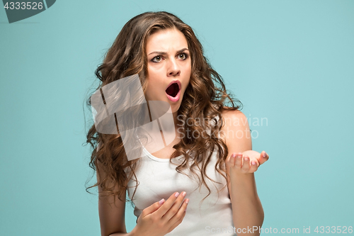 Image of Portrait of young woman with shocked facial expression