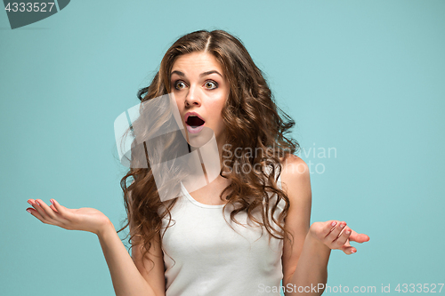 Image of Portrait of young woman with shocked facial expression