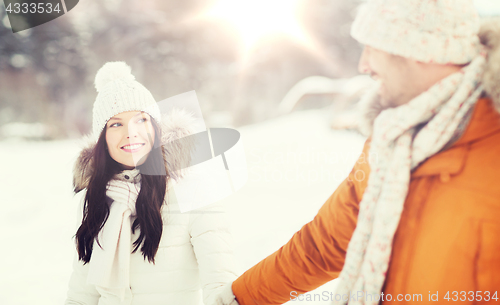 Image of happy couple walking over winter background