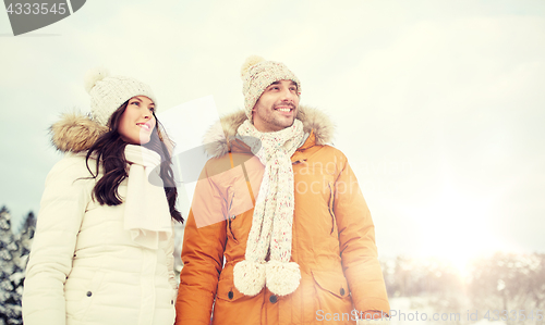 Image of happy couple walking over winter background