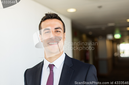 Image of businessman in suit at hotel corridor 