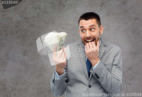 Image of greedy businessman with american dollar money