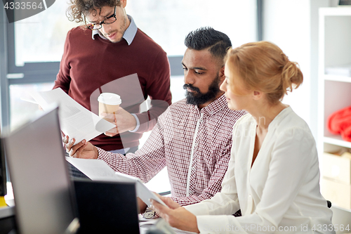 Image of business team with tablet pc in office