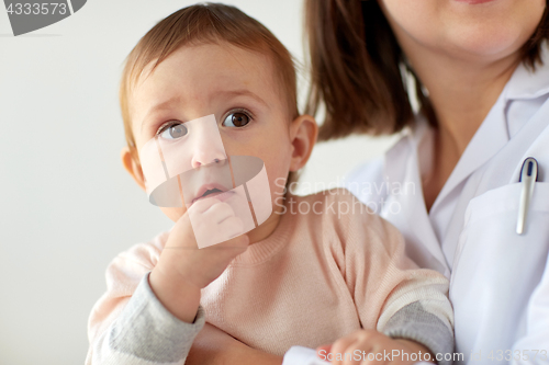 Image of doctor or pediatrician with baby on medical exam