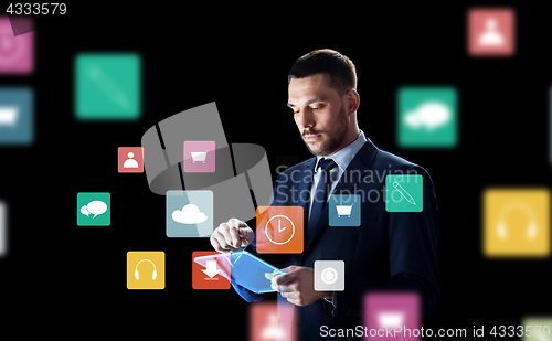 Image of businessman with tablet pc and virtual menu icons