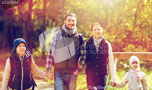 Image of happy family with backpacks hiking