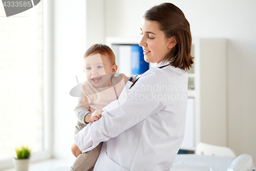 Image of doctor or pediatrician holding baby at clinic