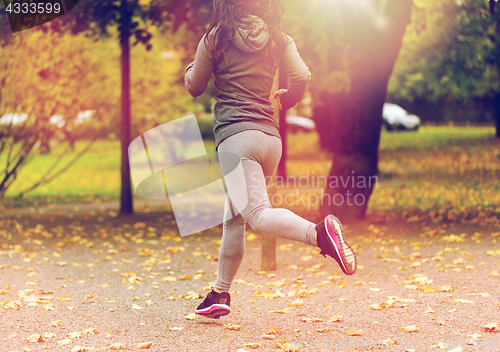 Image of close up of young woman running in autumn park
