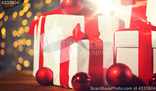 Image of gift boxes and red balls on wooden floor