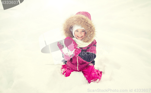 Image of f happy little child or girl with snow in winter